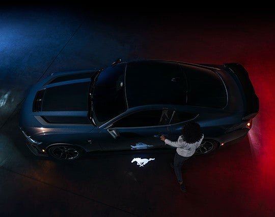 2024 Ford Mustang® Dark Horse™ model with a driver approaching the vehicle | Serra Ford Rochester Hills in Rochester Hills MI