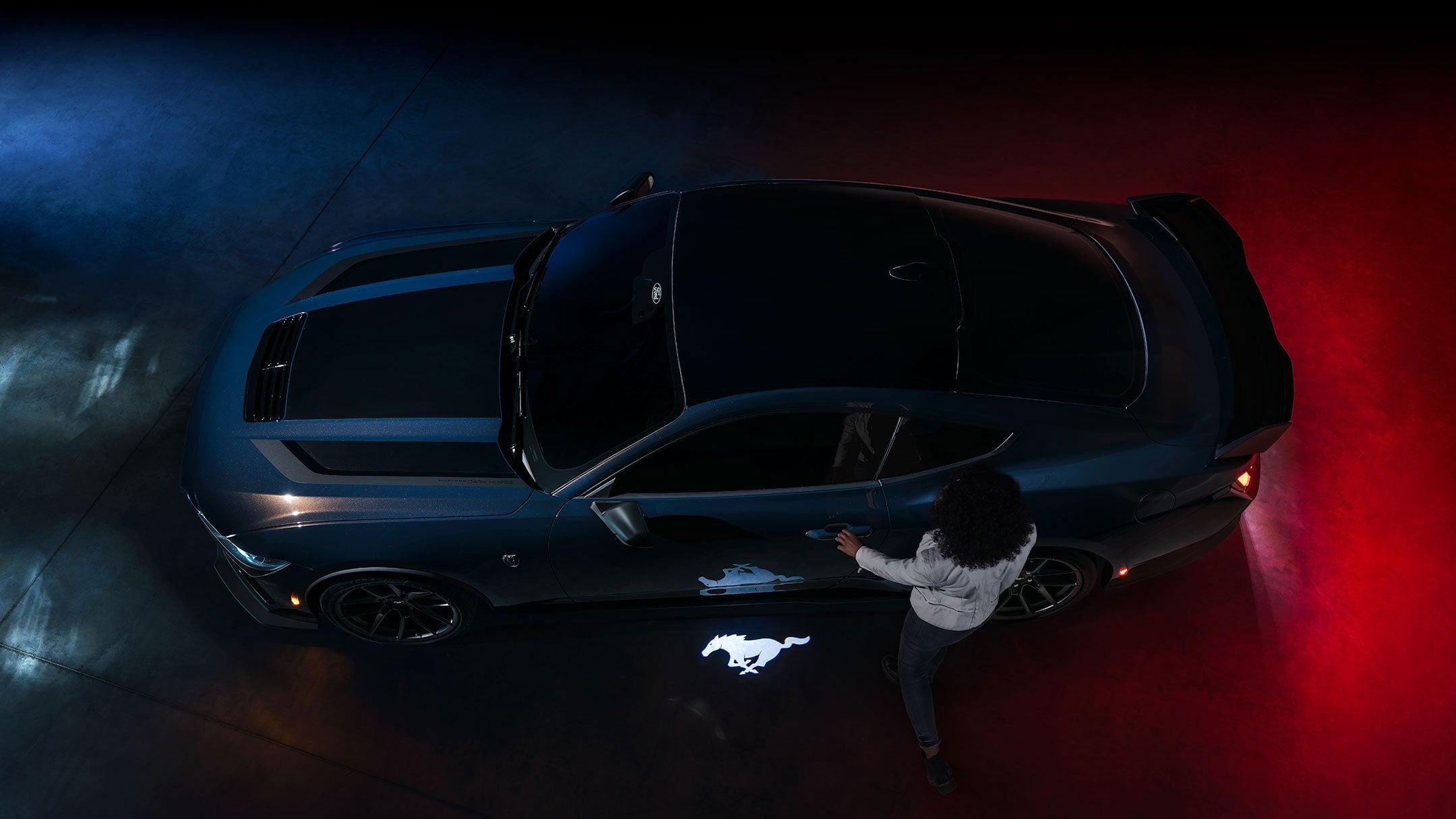 2024 Ford Mustang® Dark Horse™ model with a driver approaching the vehicle | Serra Ford Rochester Hills in Rochester Hills MI