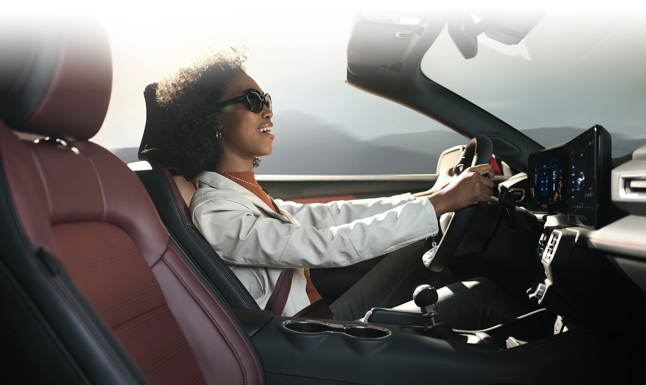 Person sitting in the driver’s seat of a 2024 Ford Mustang® convertible | Serra Ford Rochester Hills in Rochester Hills MI