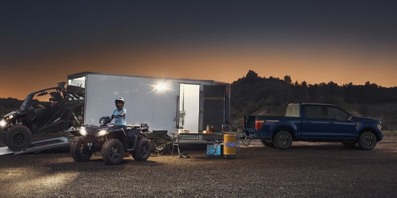 Person using a TIG welder that's plugged into the Pro Power Onboard feature located in the truck bed